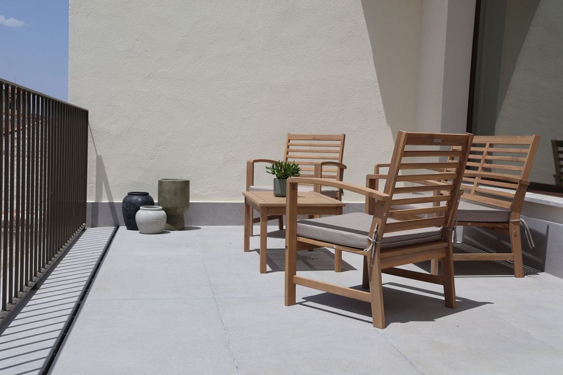 Sillas y mesa de madera en terraza de piso superior